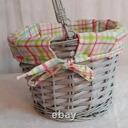 Cute decorative basket lined gray with pink green & blue inside